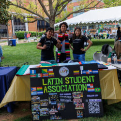 Students posing behind a table for the Latin Student Association