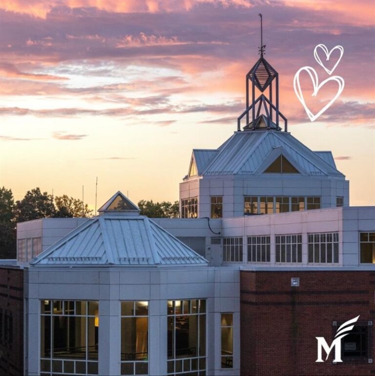 A photo of the sunset over the Johnson Center with hearts drawn in the corner