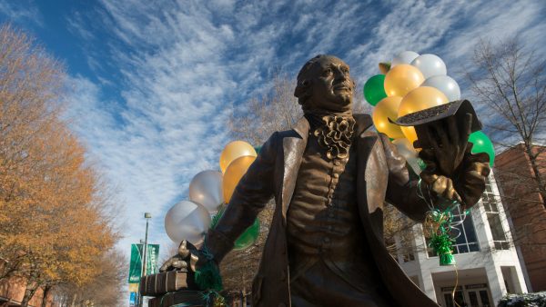 George Mason statue with green and gold balloons. Photo by Evan Cantwell/Creative Services/George Mason University