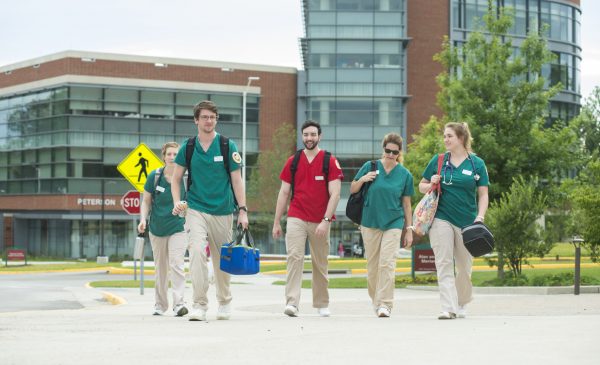 School of Nursing students walking on campus in front of Peterson Family Sciences Hall. Photo by Evan Cantwell/Creative Services/George Mason University